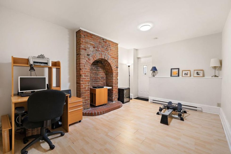A basement room at 1828, rue Tupper with a former kitchen hearth.