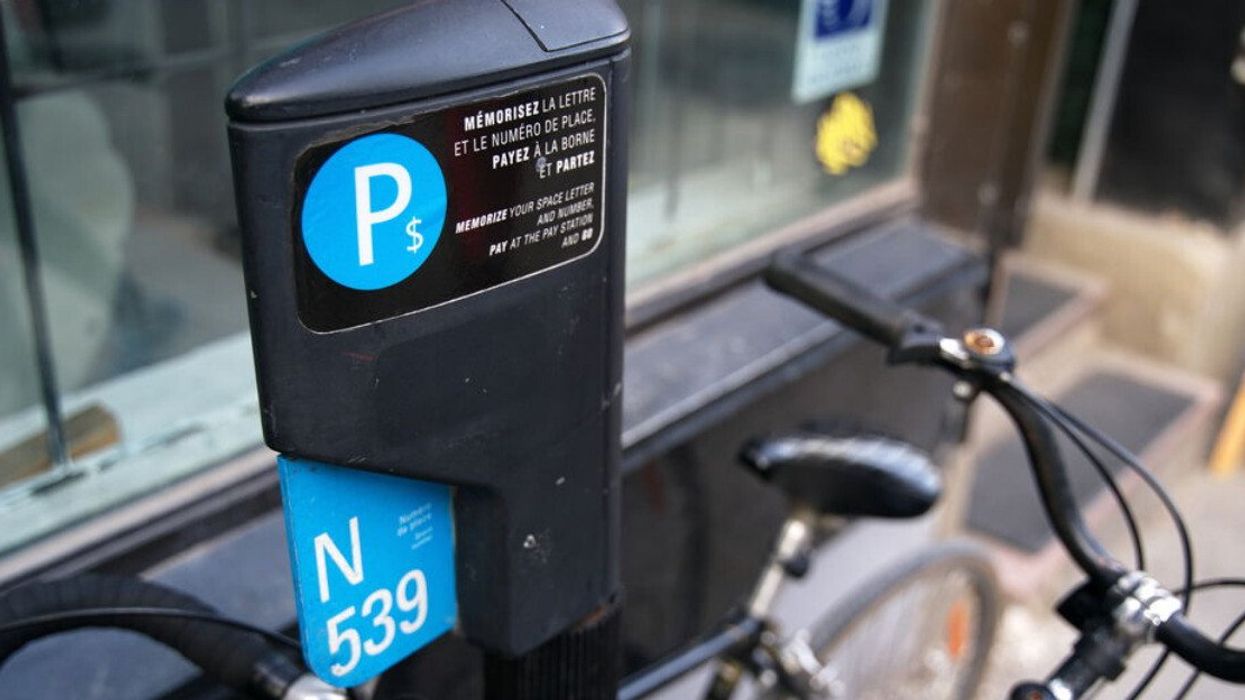 A bike leans on a Montreal parking metre.
