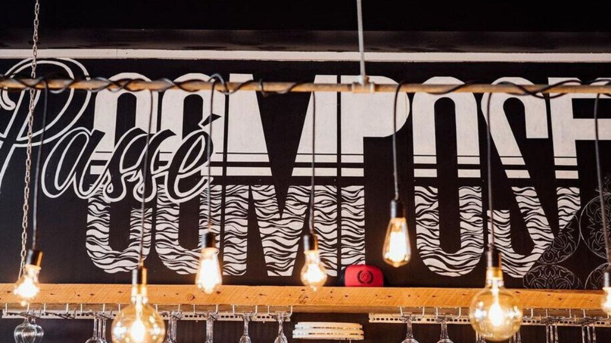 A black and white mural reading "Passé Composé" in the brunch spot's Ville-Marie location.