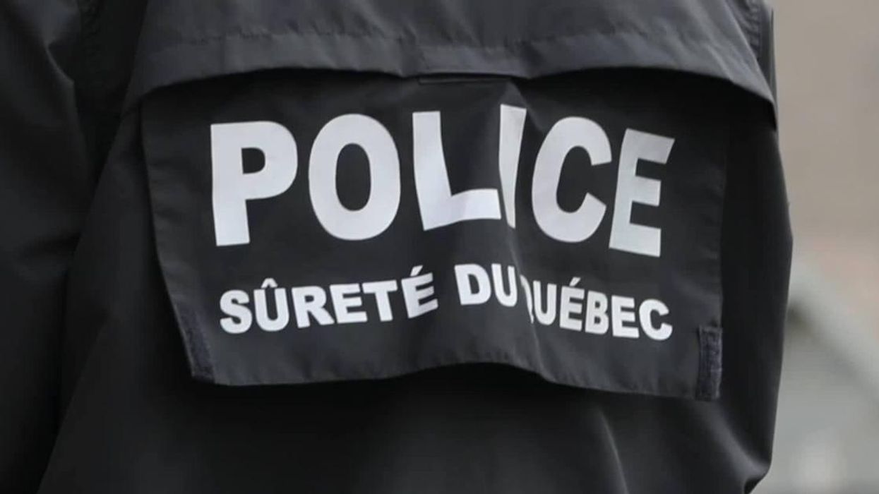 A black coat reading "POLICE, Sûreté du Québec."