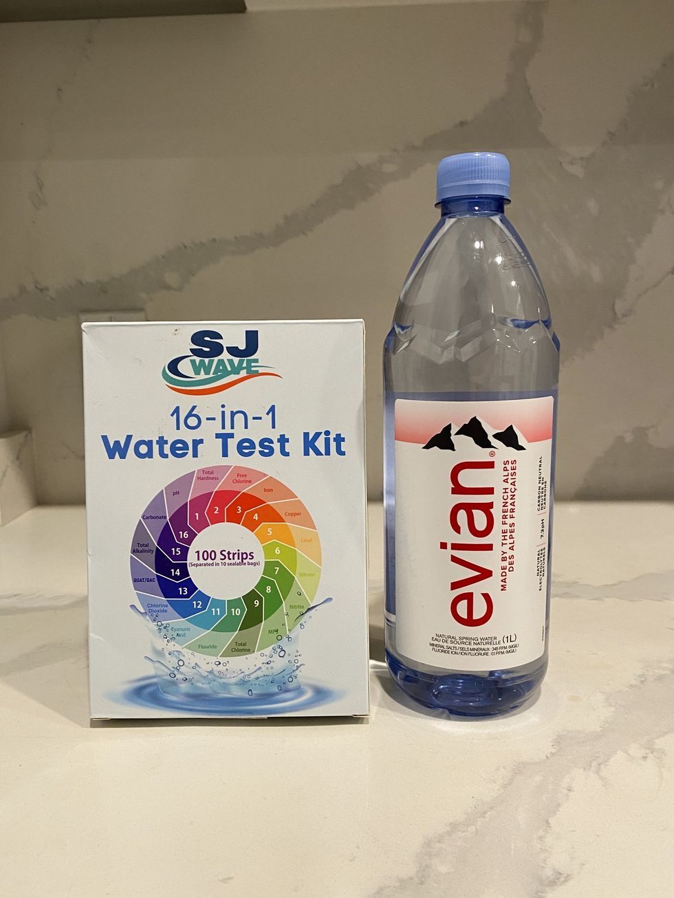 A bottle of Evian water and a 16-in-1 water test kit.\u200b