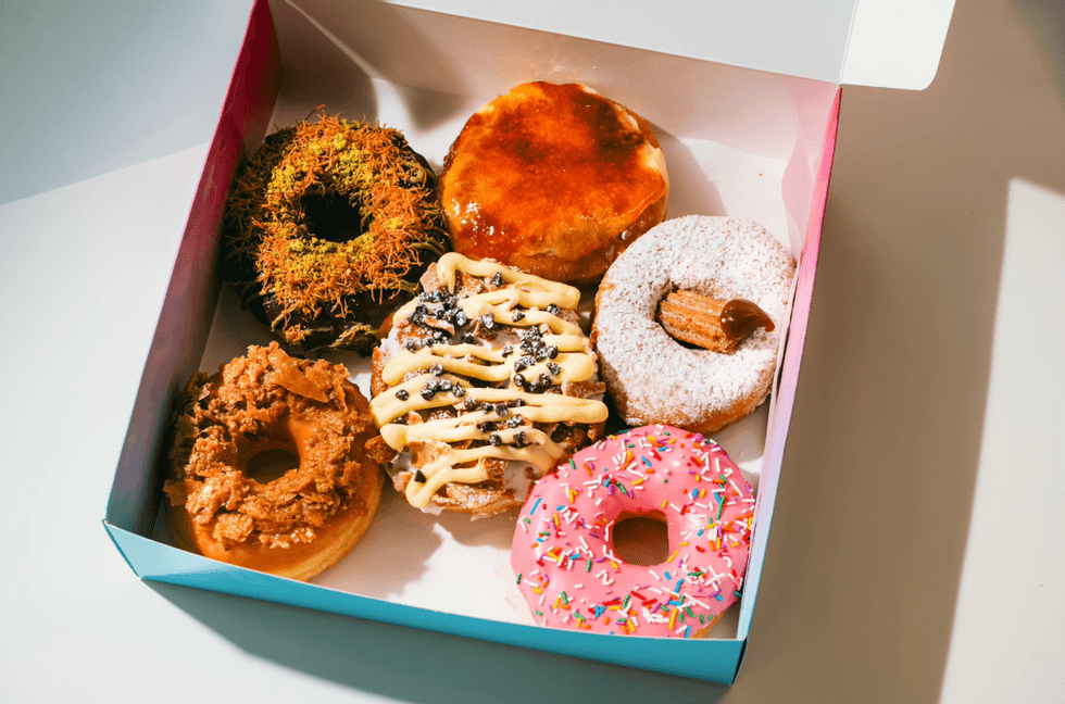 A box of different colourful donuts.