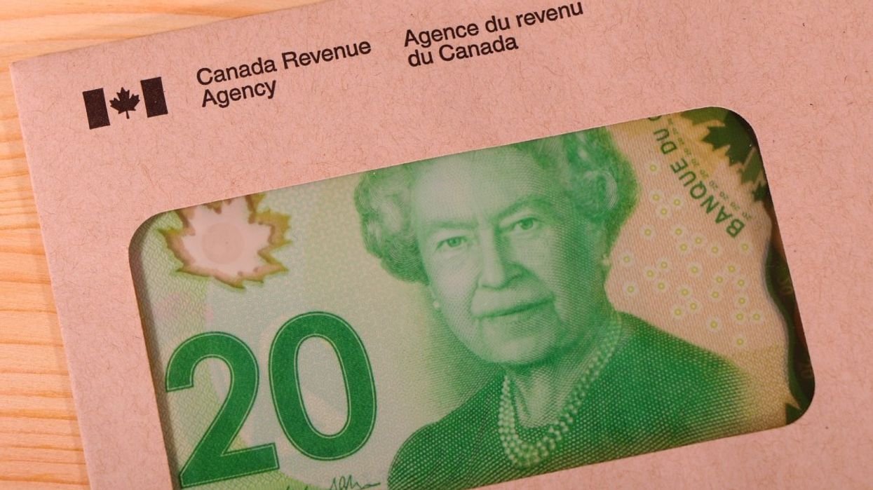 A Canada Revenue Agency envelope with a Canadian $20 bill inside.