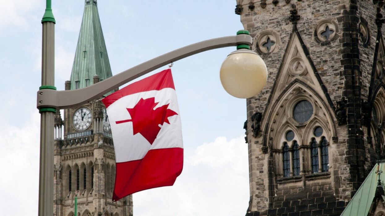 A Canadian flag hangs from a light post on Parliament Hill in Ottawa.