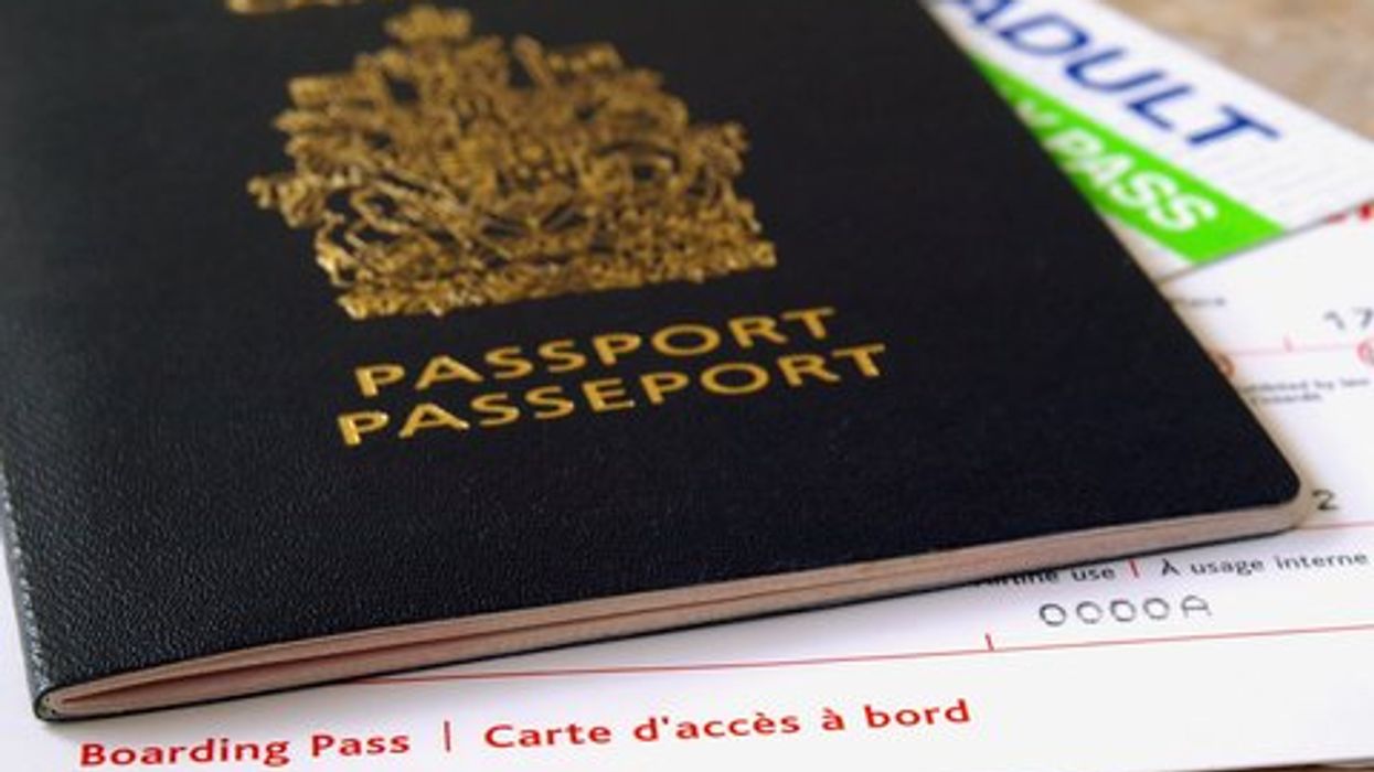 A Canadian passport with a boarding pass on a table.