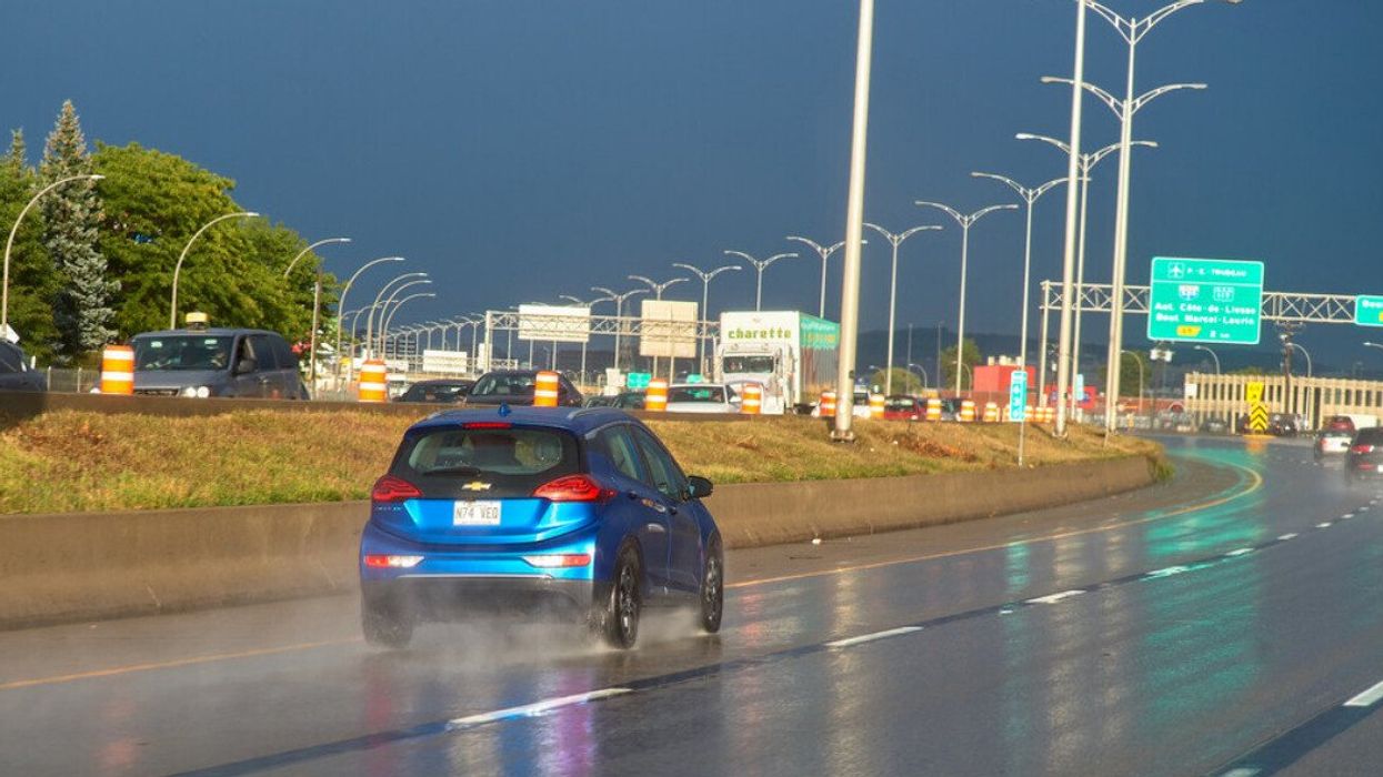 A car drives through a rain storm in Montreal.