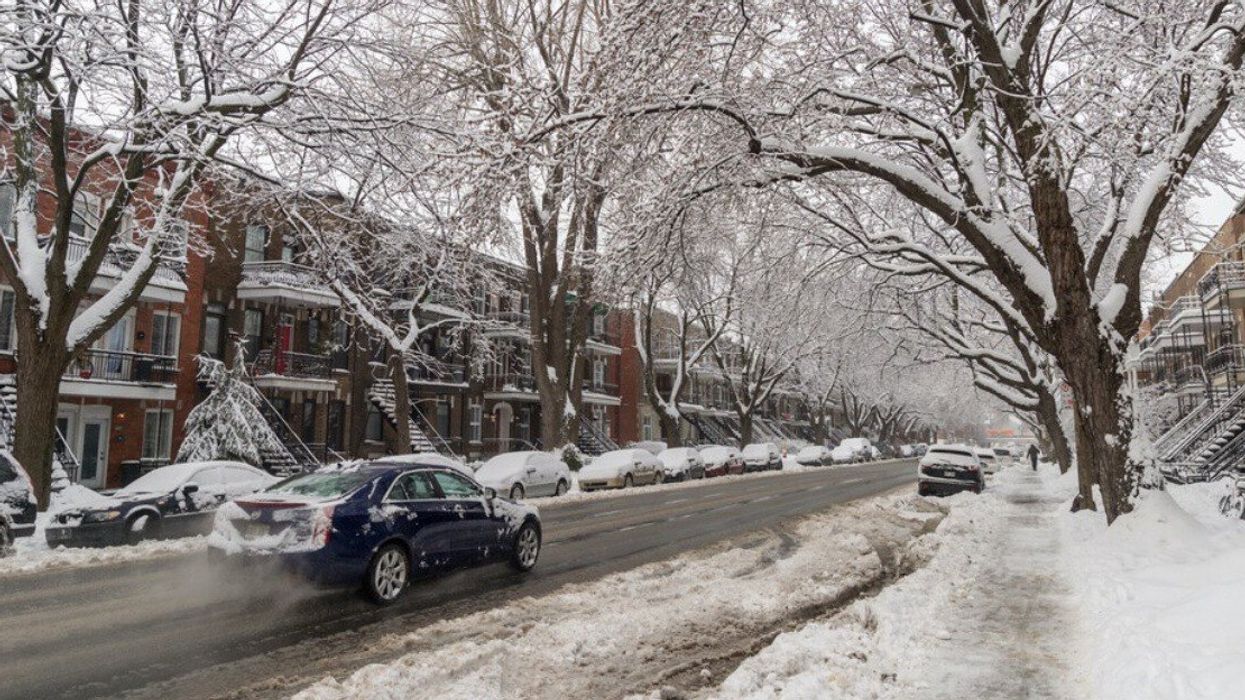 A car driving on a snowy road in Montreal.