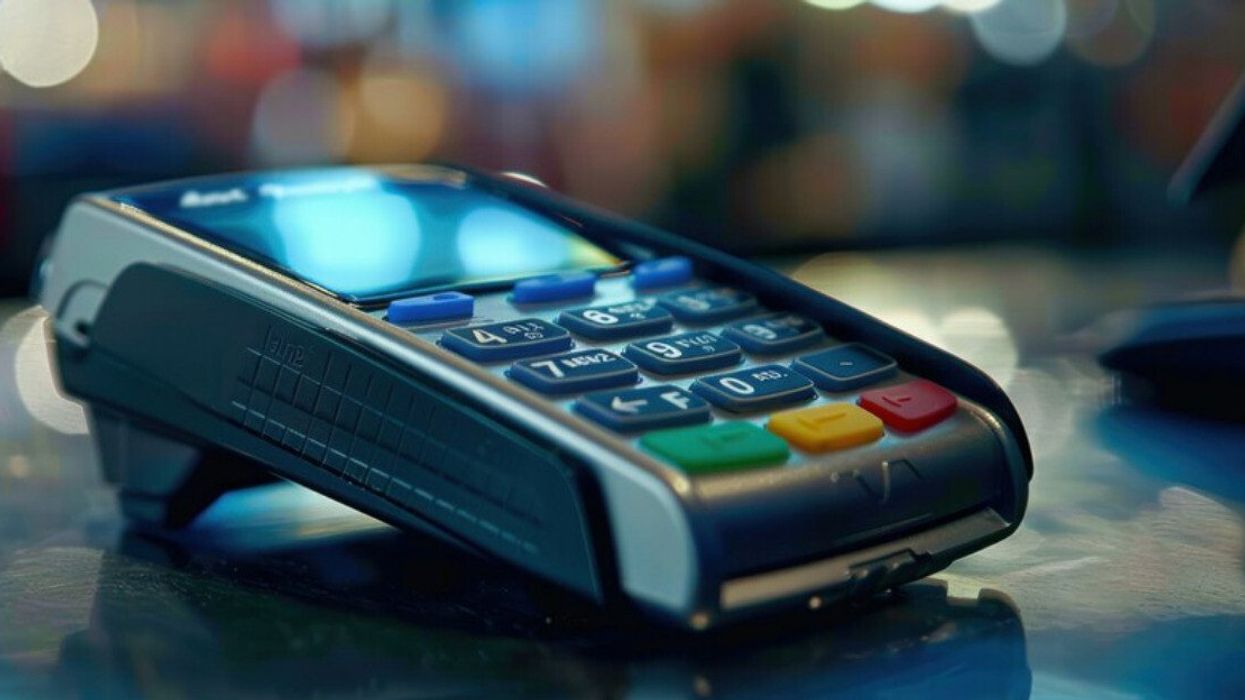 A card payment machine on a counter.