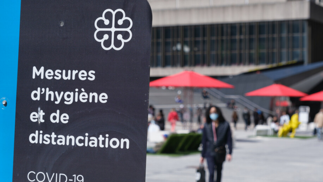 A close-up of a Montreal COVID-19 hygiene and social distancing sign.