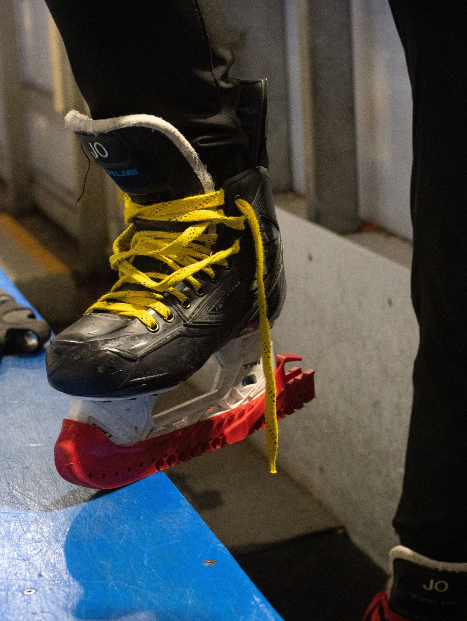 A close-up of Jojo's ice skates that have a "Jo" on the tongue of each boot.