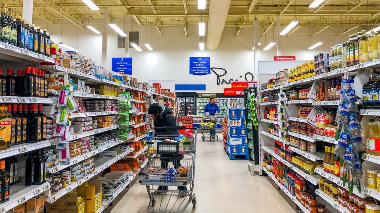 A couple of people shopping at a Canadian grocery store.