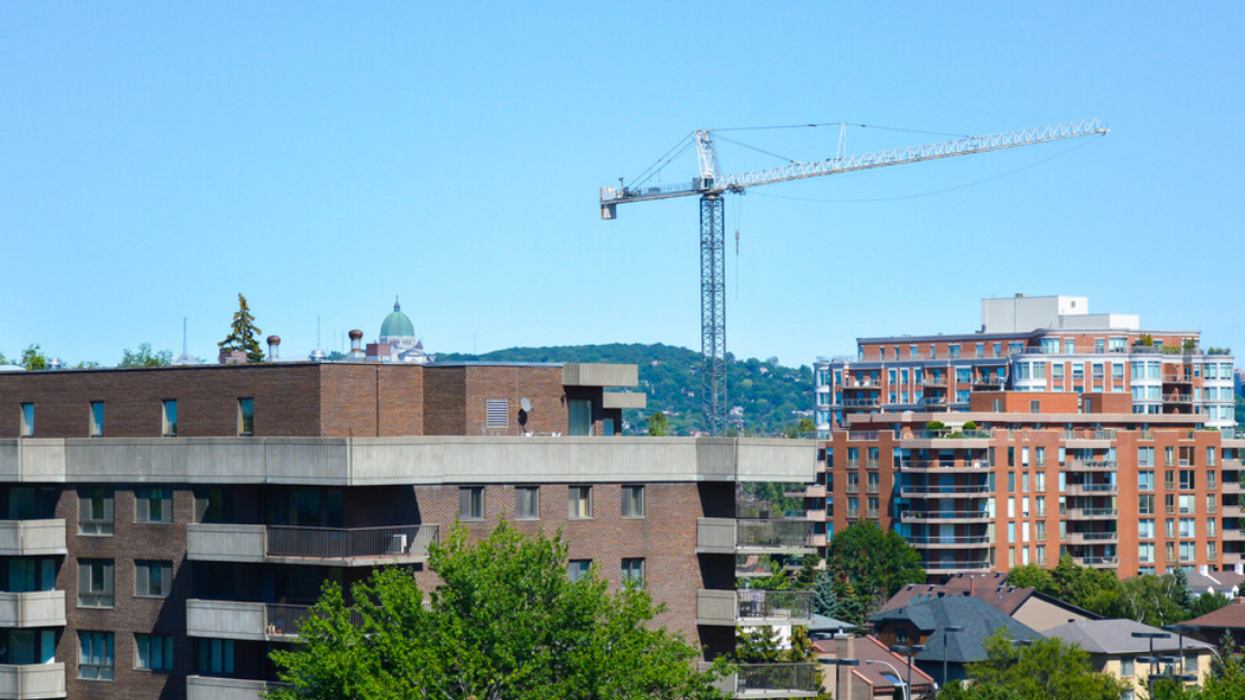 A crane hangs above condo and apartment buildings being constructed in Cote Saint-Luc, Quebec, Canada.