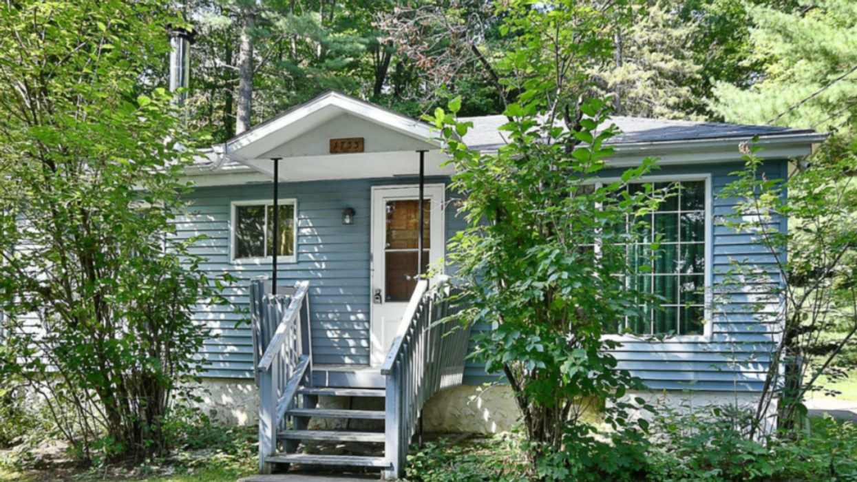 A cute blue cottage in the Quebec woods.