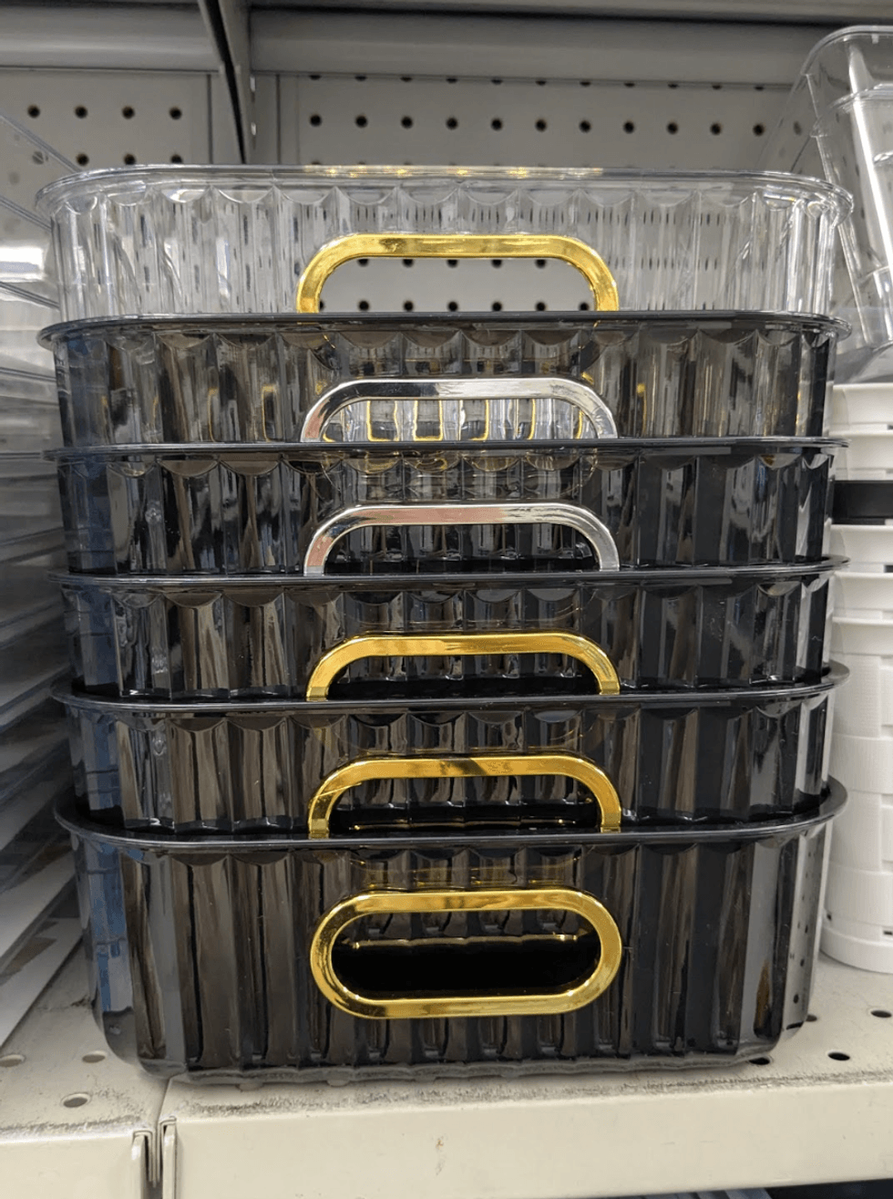 A decorative plastic tray with gold and silver trim