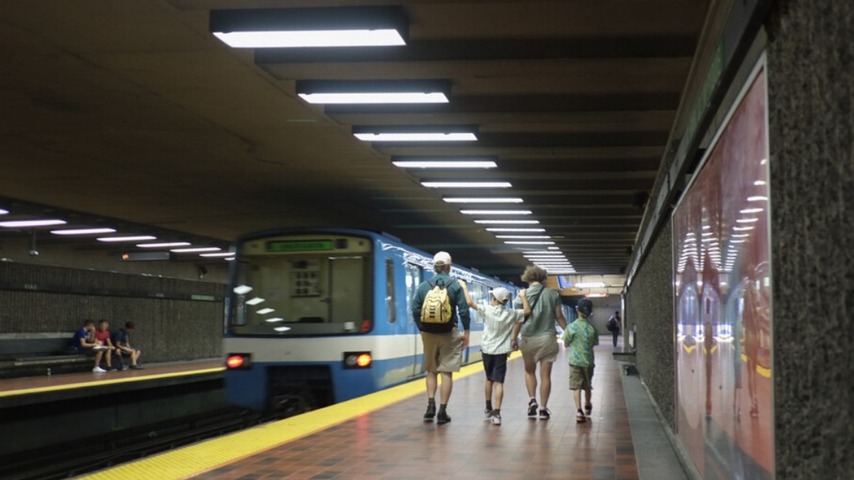 A family walks along the platform at Viau station.