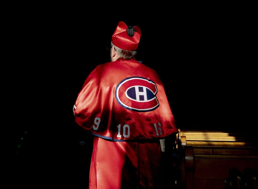 A fan dressed in a Montreal Canadiens themed cardinal cassock enters the Cathedral of Saint-Jean-l'Evangeliste.