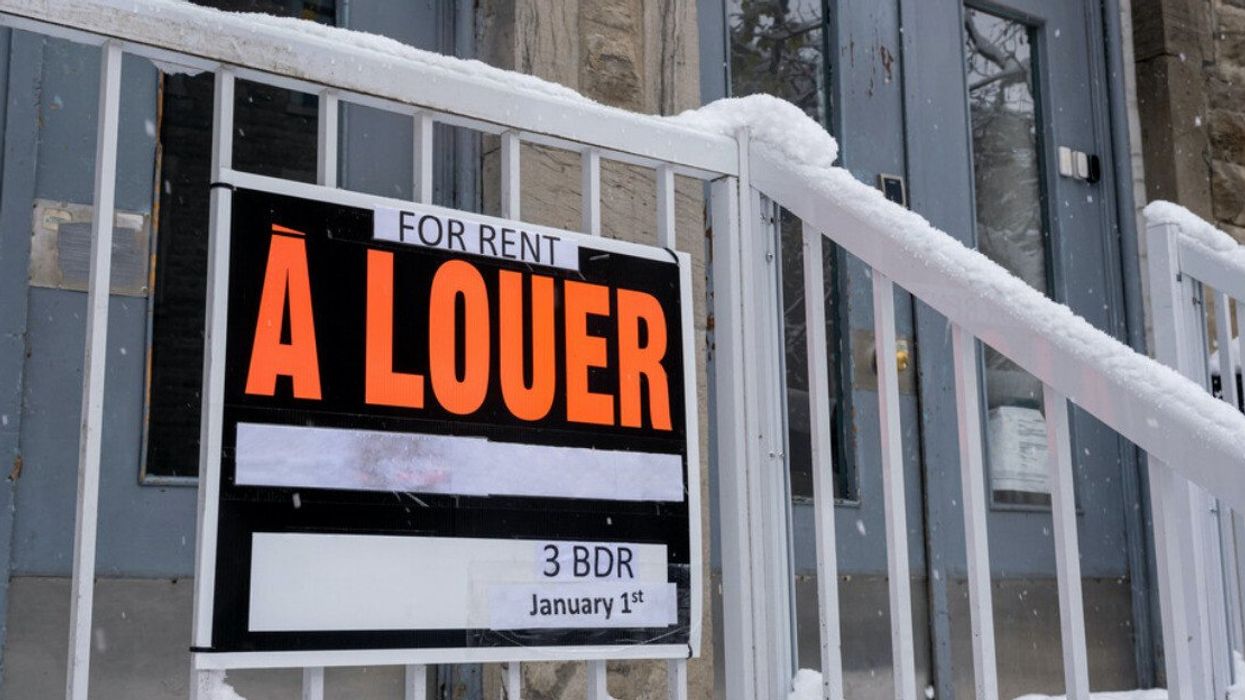 A for rent sign hangs on a snowy Montreal stairwell.