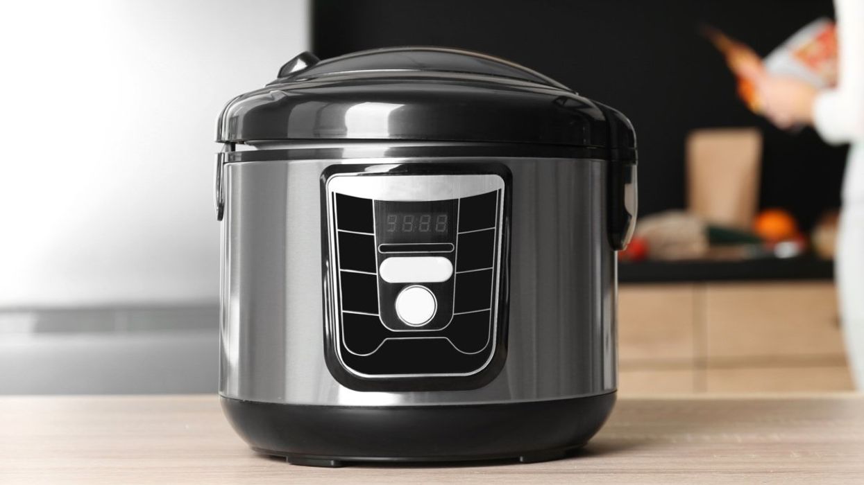 A generic grey and black pressure cooker sitting on top of a kitchen counter.