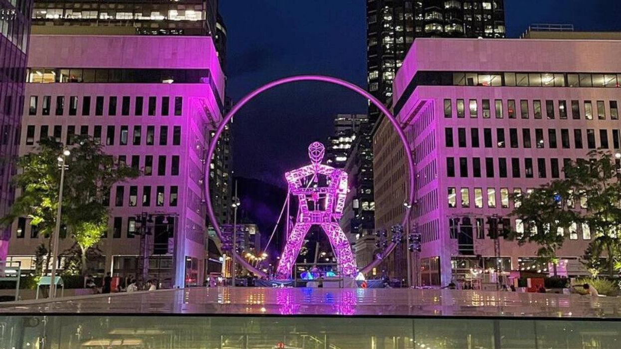A giant person-shaped structure near Montreal's downtown ring.