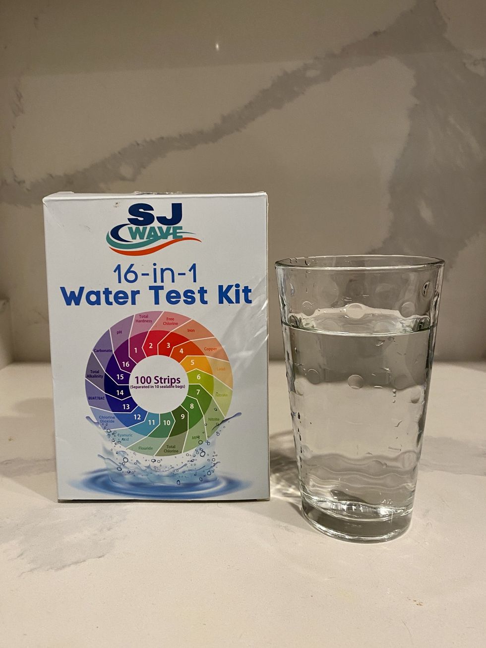 A glass of tap water from a Montreal apartment and a 16-in-1 water test kit.\u200b