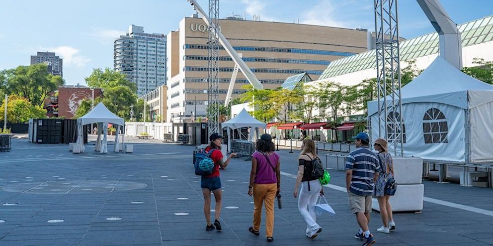 A group of people walking around Downtown Montreal. \u200b