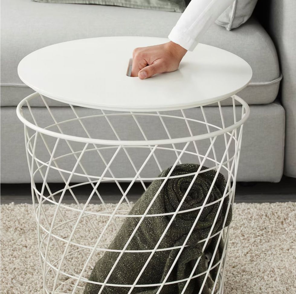 A hand placed on the KVISTBRO storage table.