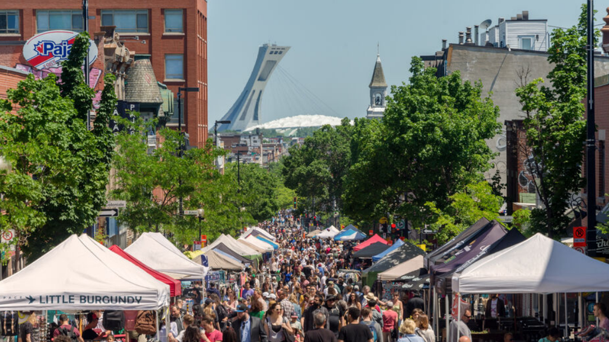 A large crowd walks along the pedestrianized Avenue Mont-Royal in Montreal during a summer sidewalk sale in June 2018.