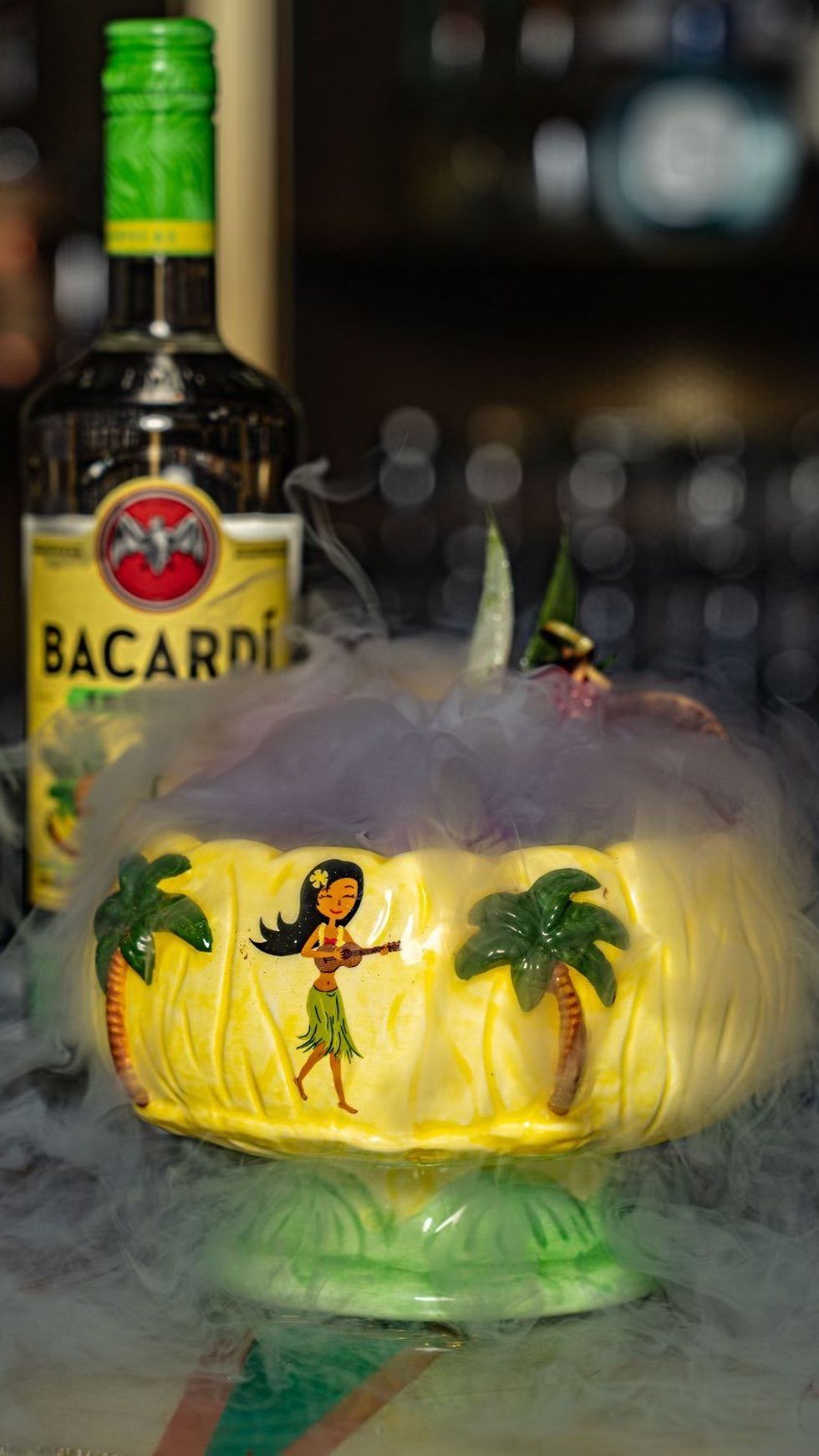 A large, tiki-themed drink with smoke coming out of it.