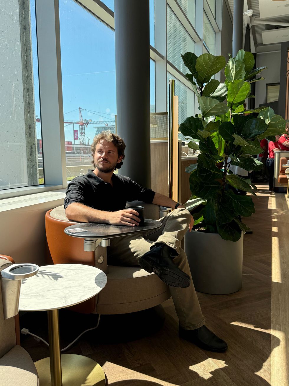 A man sits in a Montreal Airport lounge. 
