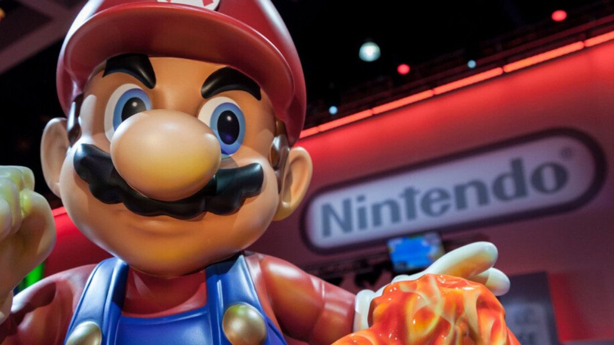 A Mario statue in front of the Nintendo logo.