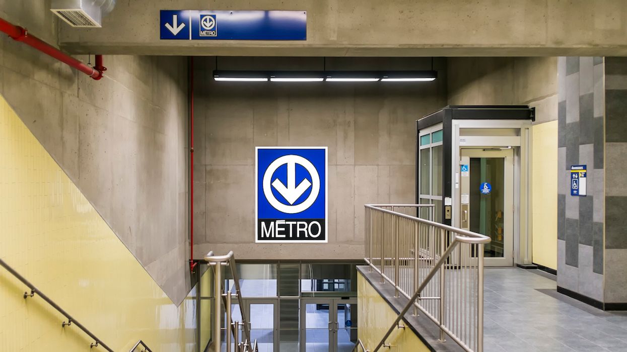 A Montreal metro sign above stairs.