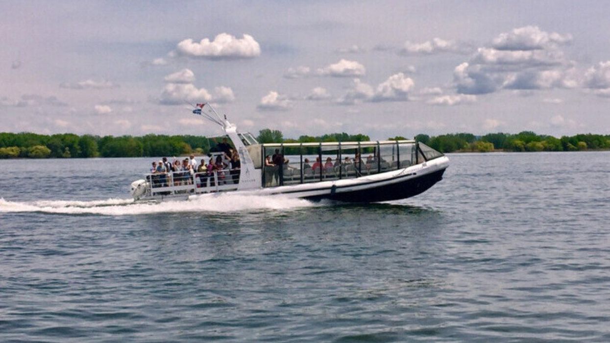 A Montreal water taxi carries passengers on the Saint Lawrence River.