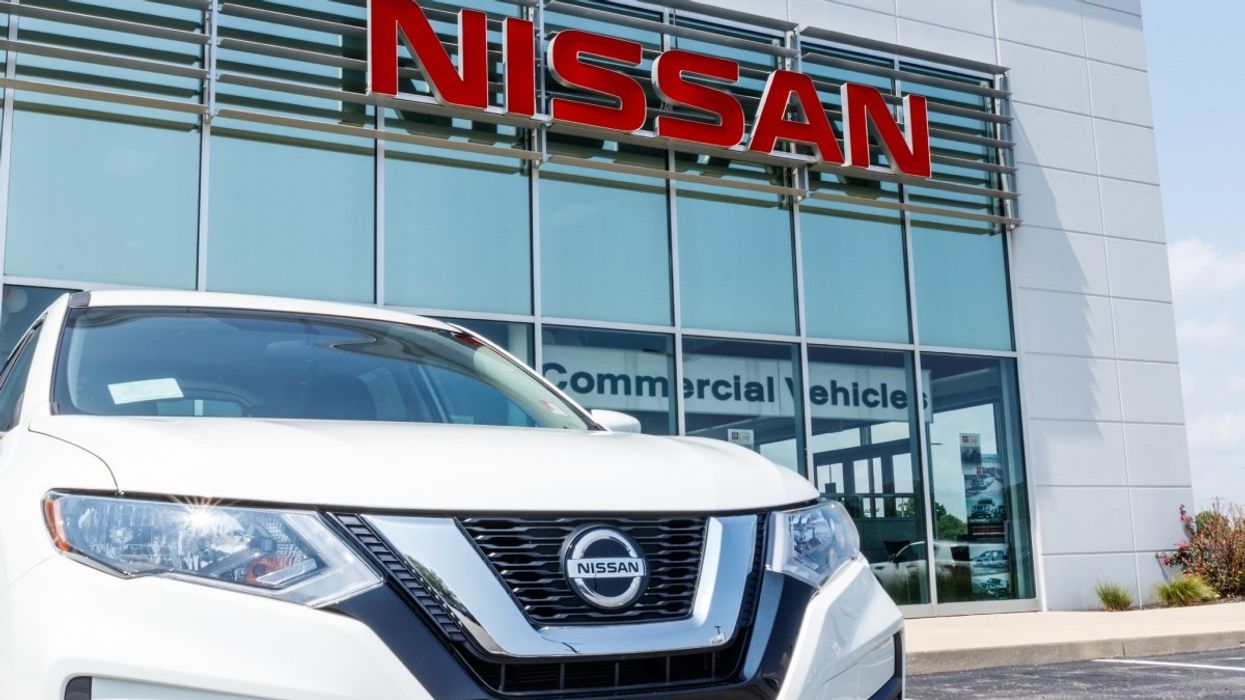 A Nissan Rogue parked outside of a Nissan car dealership.