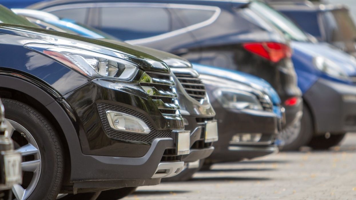 A number of cars parked in a lot.