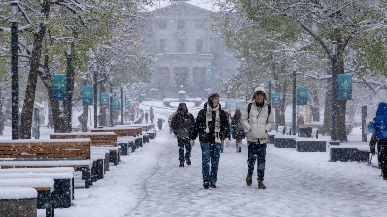A number of McGill University students walking away from the school campus during the wintertime.