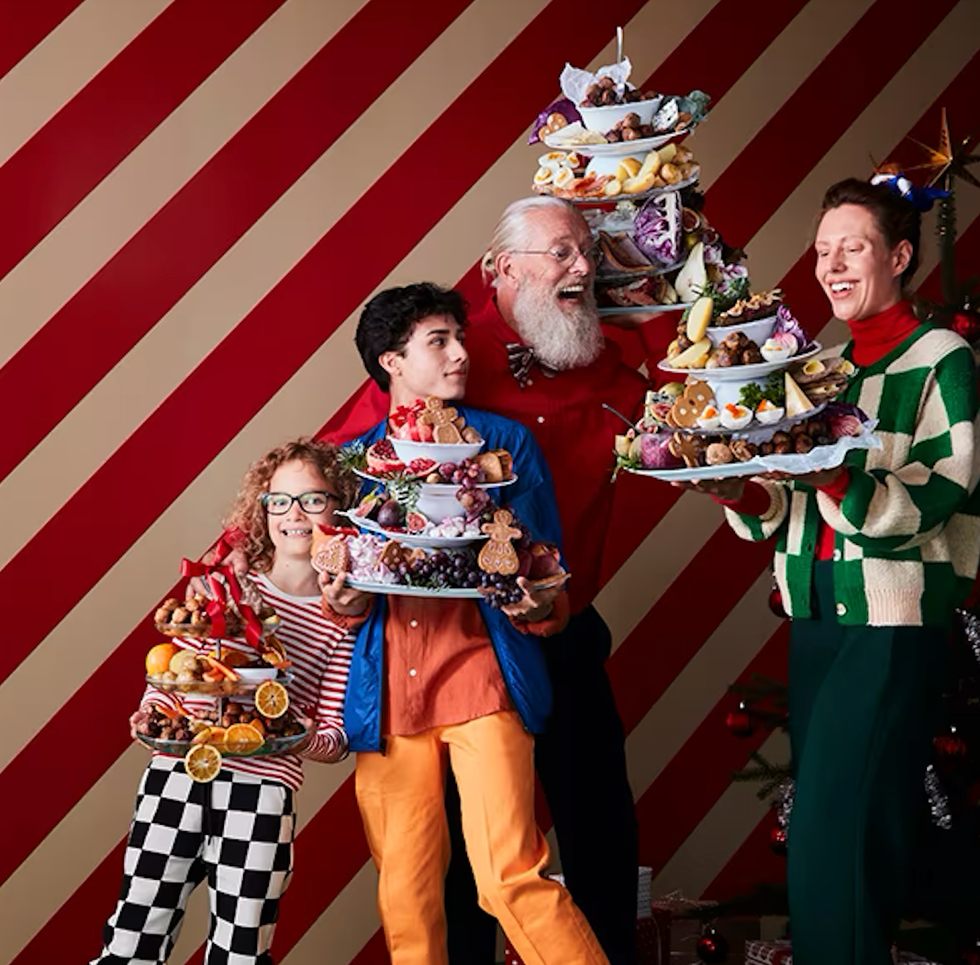 A number of people holding stacks of dishes loaded with Swedish treats from IKEA