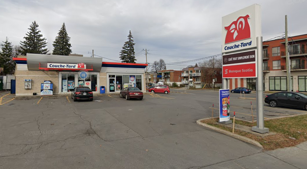 A parking lot gas station with a Couche-Tard convenience store and three cars parks in front of it.