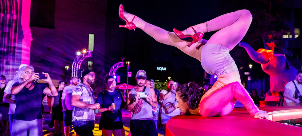 A performer poses on Saint-Denis.