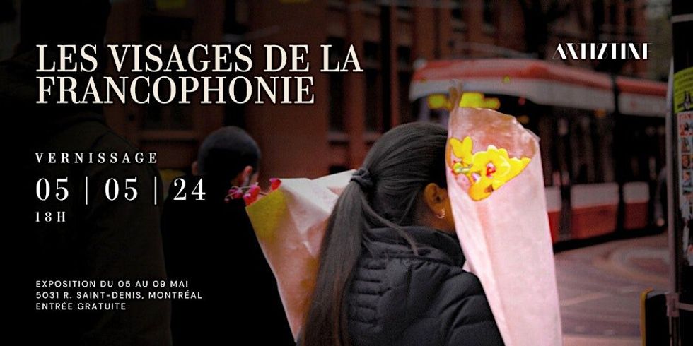 A person holding a bouquet of yellow flowers on the streets of a European city.