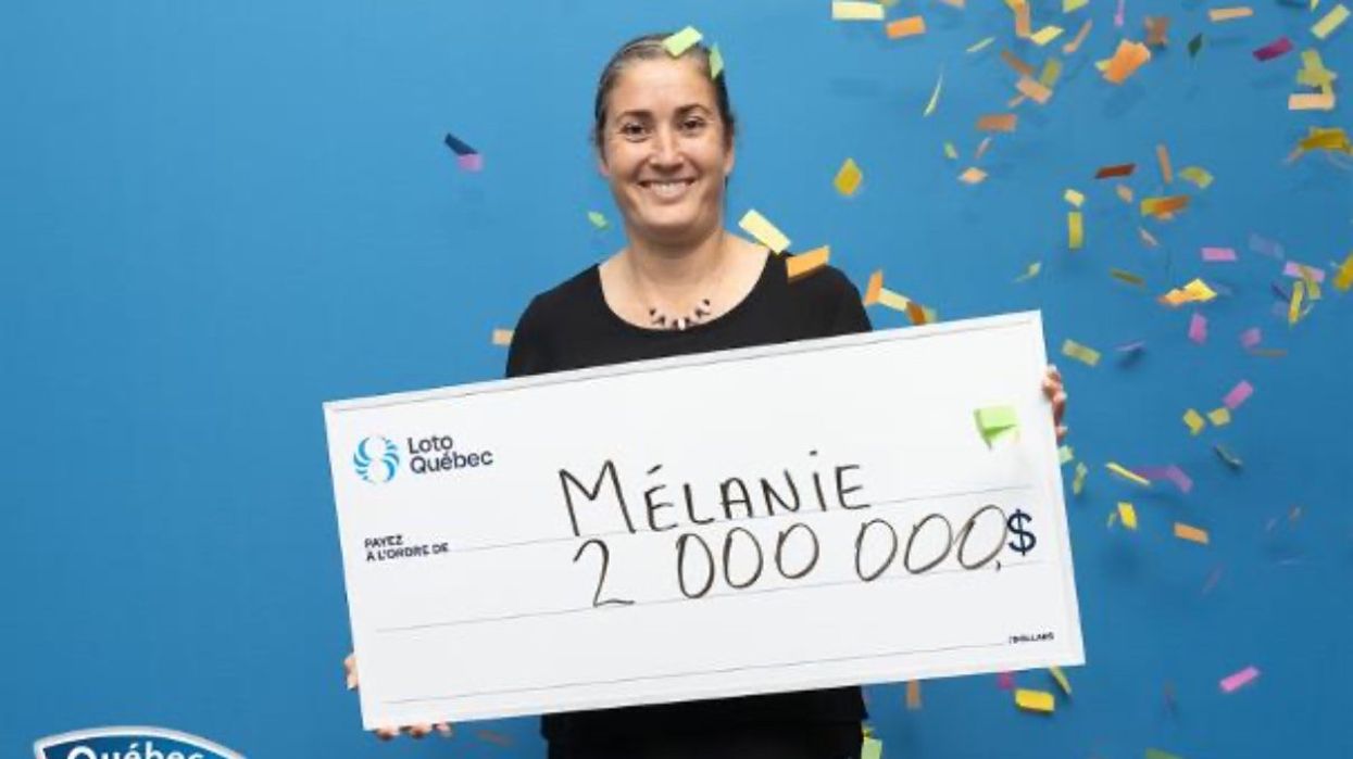 A person holding a massive cheque for $2 million at the Loto-Quebec headquarters after winning the Quebec Max.
