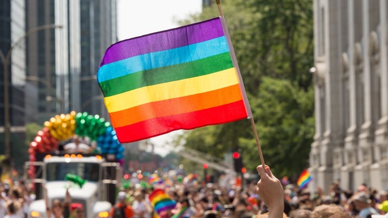 A person holding a pride flag during the Montreal Pride parade.