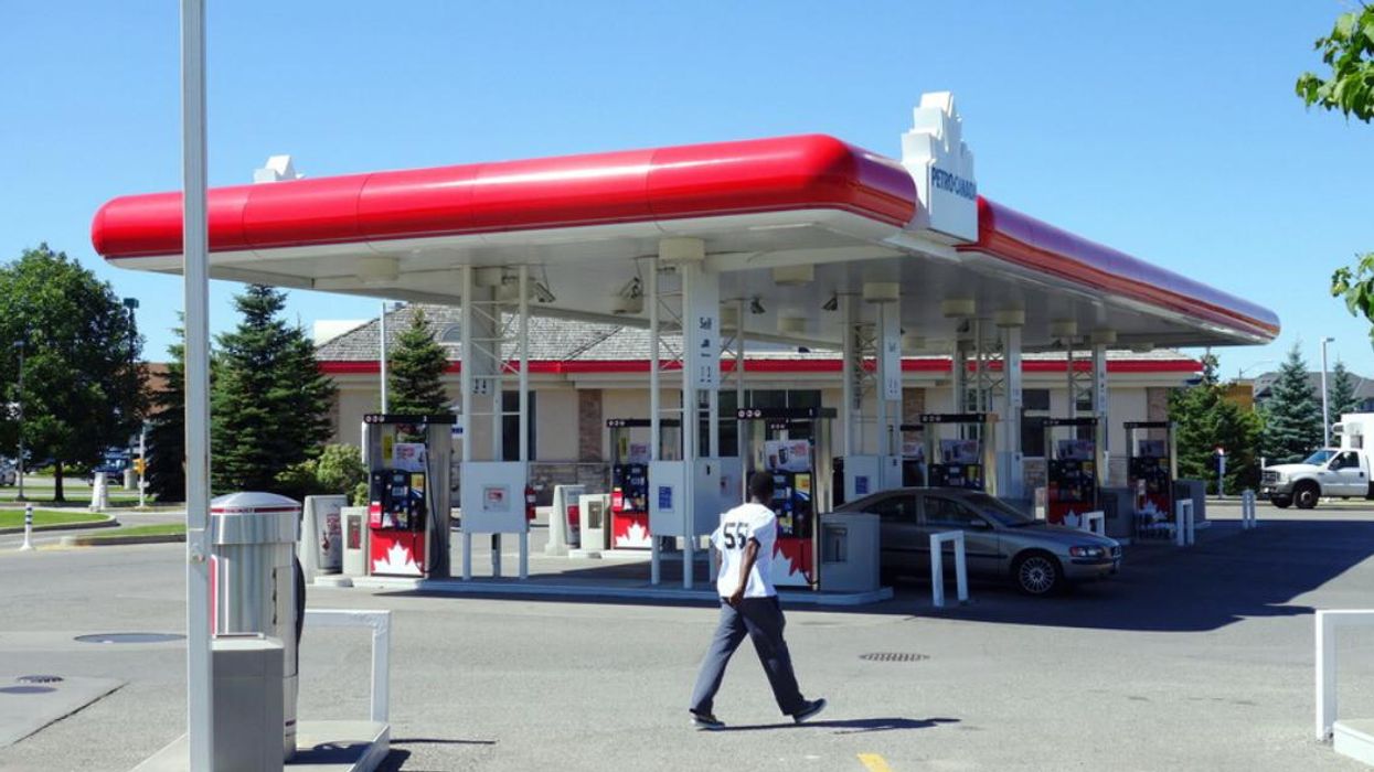 A person walks near a Petro-Canada gas station.