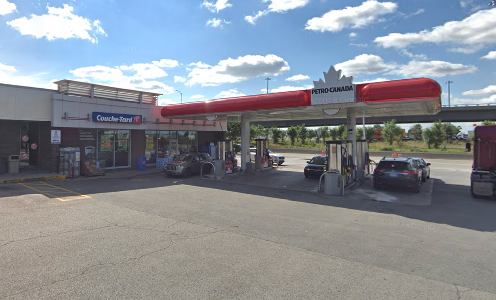 A Petro-Canada gas station attached to a Couche-Tard convenience store with several cars pumping gas.