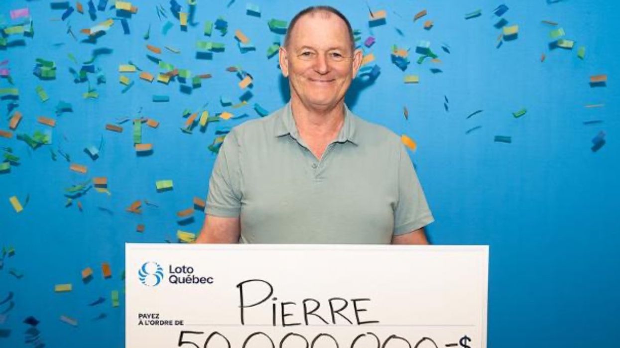 A photo of a Loto-Quebec lottery winner holding a giant cheque of $50,000,000.
