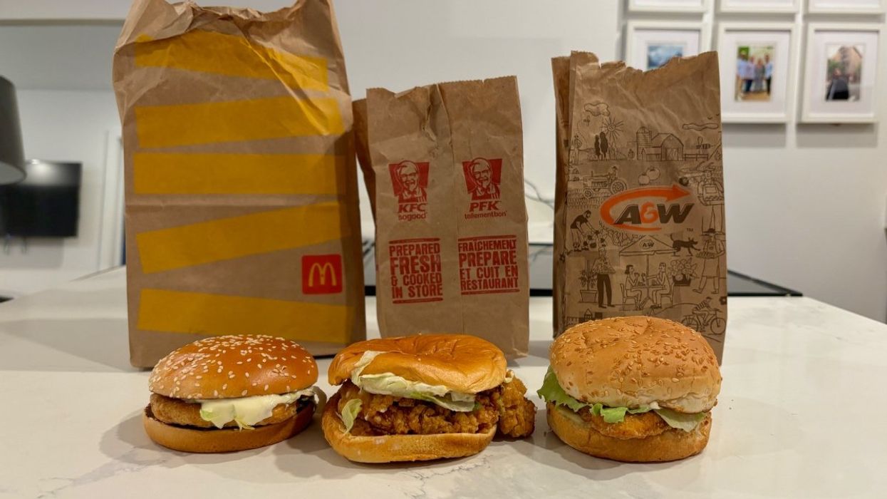 A photo of chicken sandwiches from McDonald's, KFC and A&W lined up on a countertop.