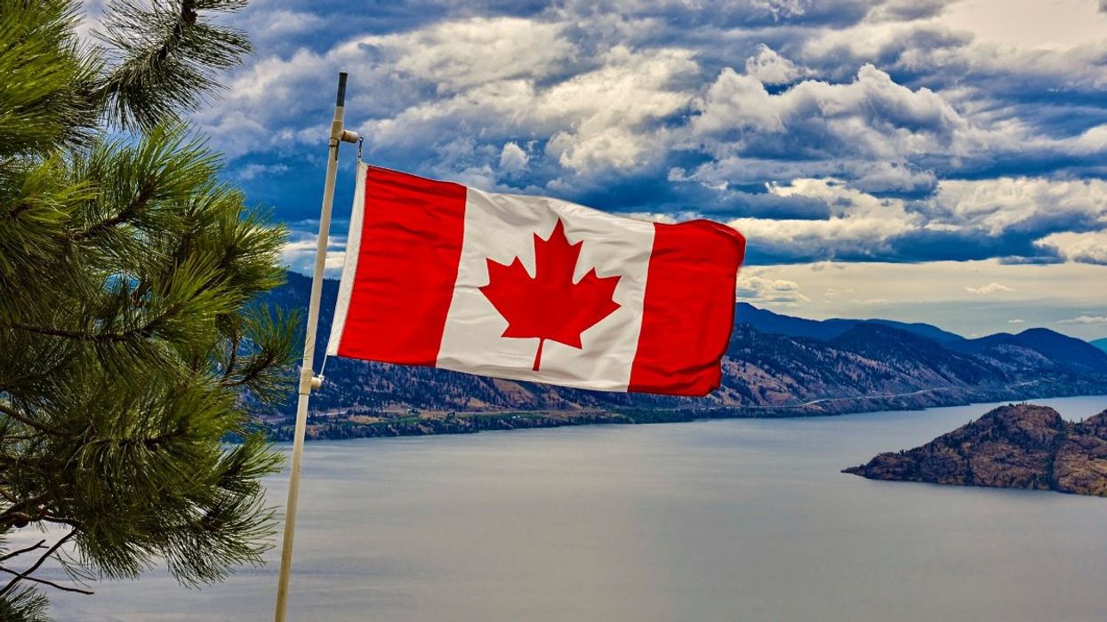 A photo of the Canadian flag flying over Okanagan Lake near Peachland, British Columbia in Canada.