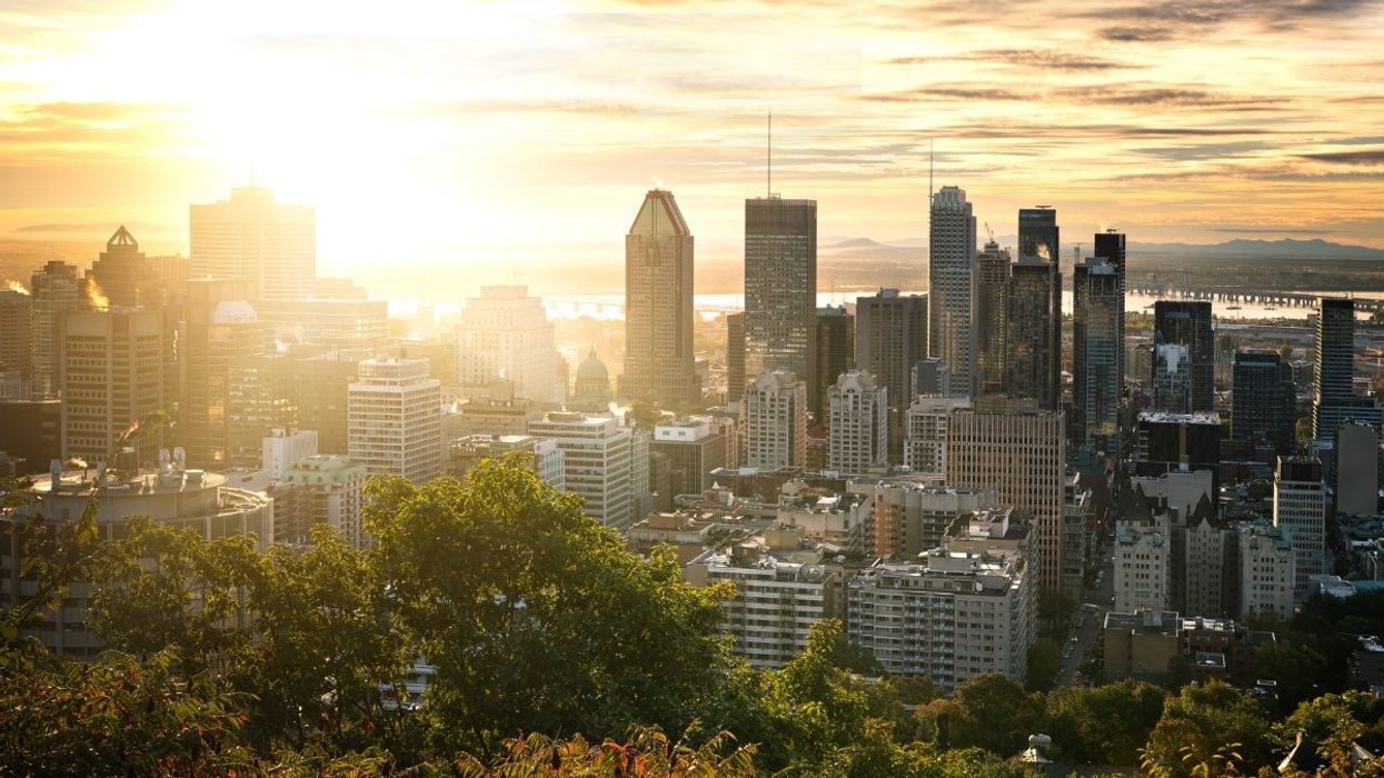 A photo of the Montreal sunrise and skyline taken from the Mont-Royal chalet lookout.