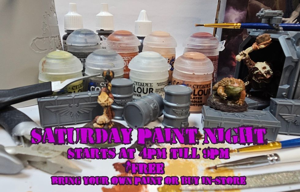 A photo of various painting supplies and a table of figurines ready to be painted. \u200b