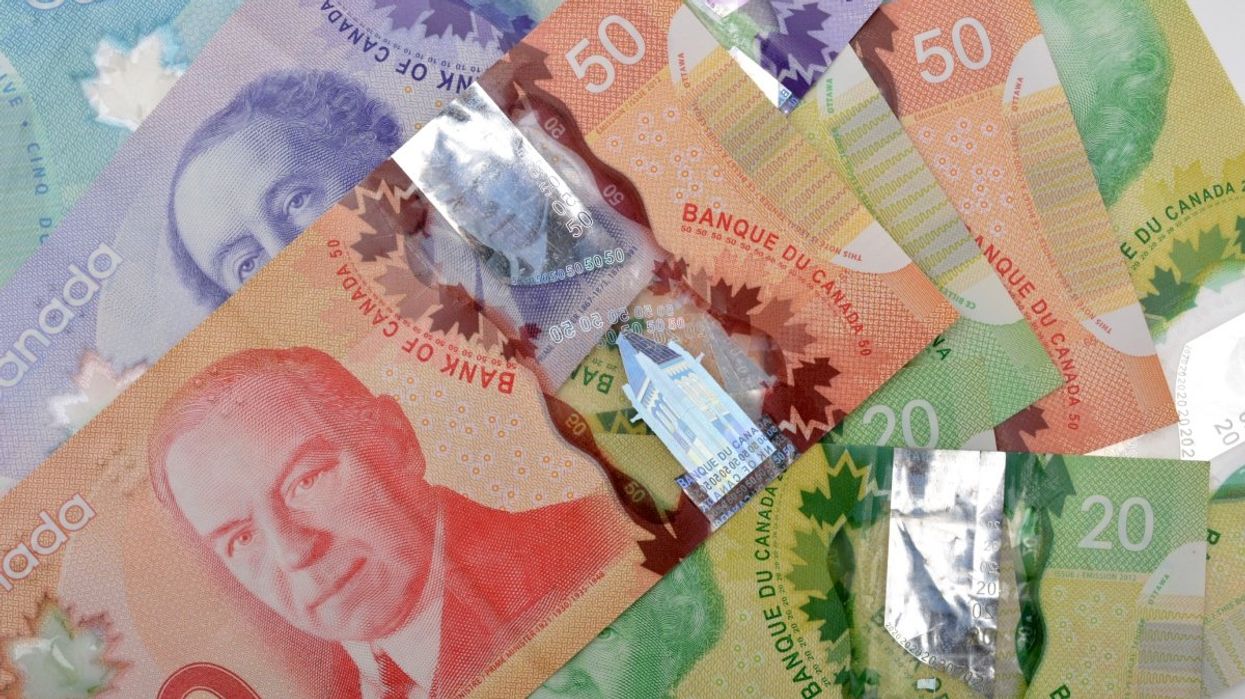 A pile of Canadian bank notes including $50, $20, $10 and $5 bills.