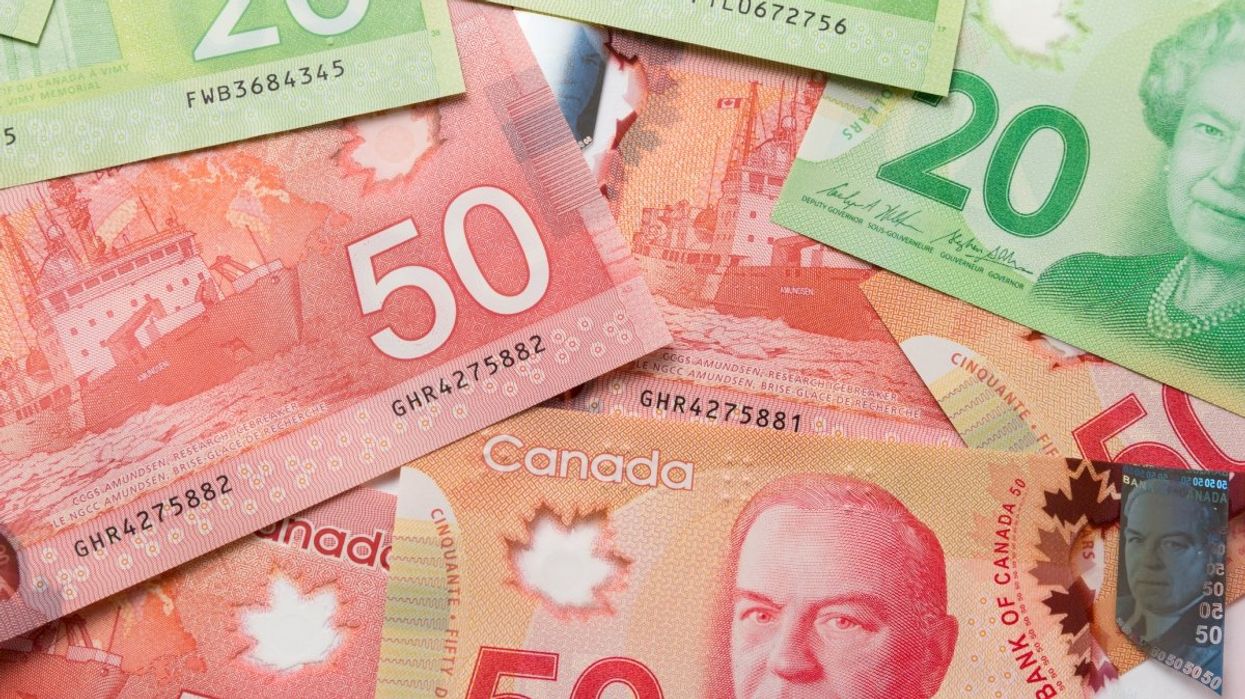 A pile of Canadian banknotes including several $50 and $20 bills.